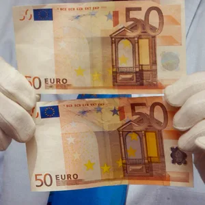 Zwei gefälschte 50-Euro-Scheine in den Händen eines Polizeiermittlers