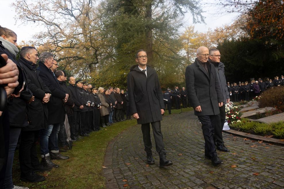 Bürgermeister Peter Tschentscher (m.) geht eine Runde um die Gedenkstätte. Mit dabei: Polizeipräsident Falk Schnabel (l.) und Staatsrat Thomas Schuster.