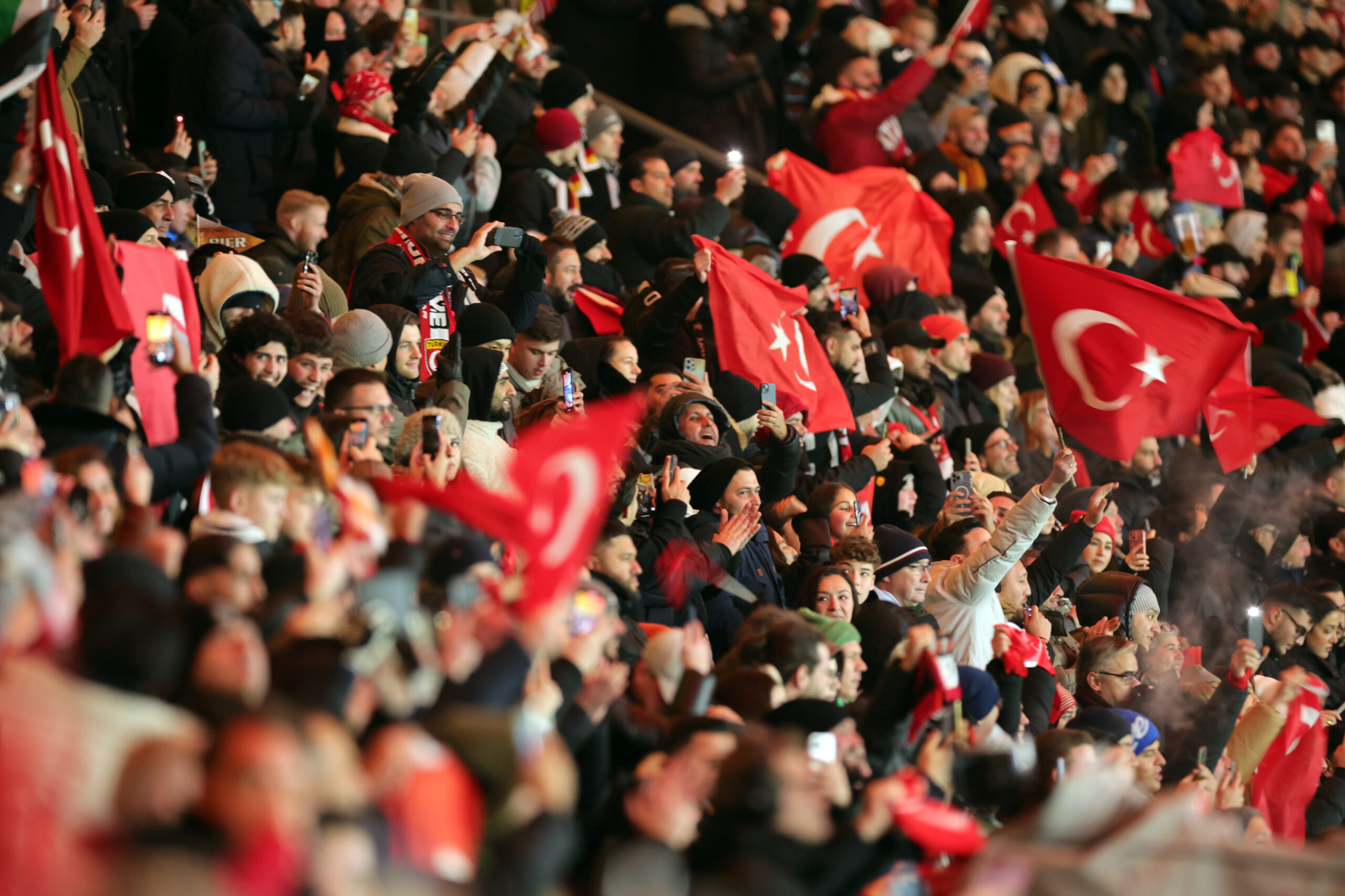 Fans im Stadion halten türkische Fahnen in die Luft