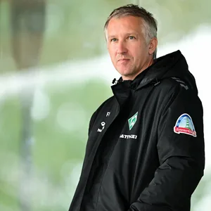 Frank Baumann in Winterjacke von Werder Bremen.