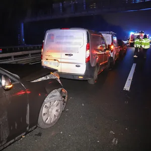 Aufnahme der Unfallstelle: Eine Reihe ramponierter Pkw stehen auf dem linken Fahrstreifen.