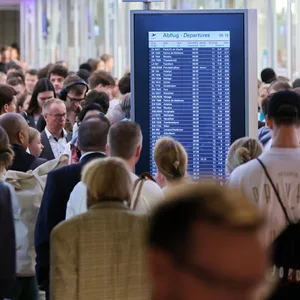 Reisende stehen in Warteschlangen an der Sicherheitskontrolle am Flughafen Hamburg. (Archivbild)