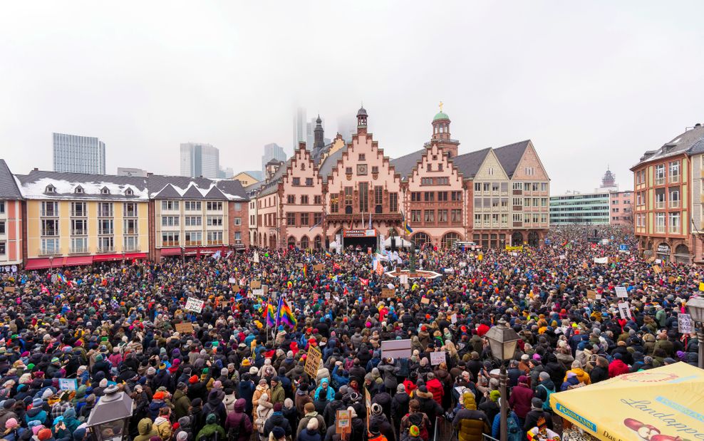 Zahlreiche Menschen haben sich zum Demonstrieren auf dem Römerberg versammelt.