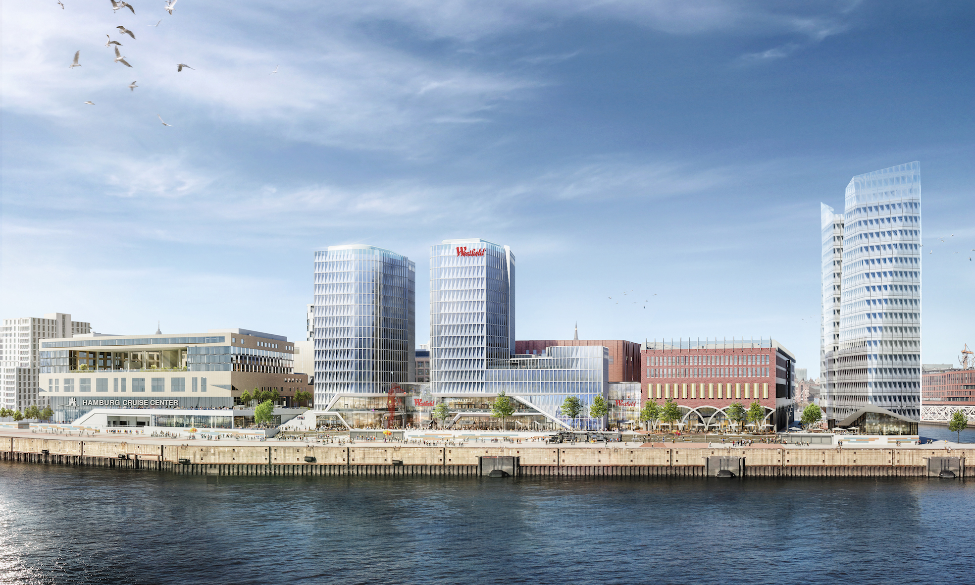Visualisierung vom „Westfield Hamburg-Überseequartier“: helle Hochhäuser und weitere Gebäude am Ufer