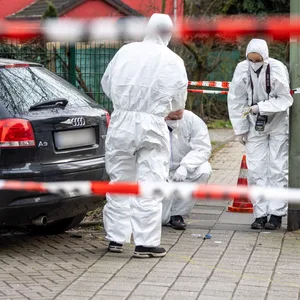 Beamte der Spurensicherung arbeiten am Tatort in Duisburg.