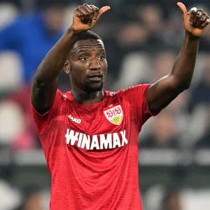 Serhou Guirassy zeigt beide Daumen nach oben im Spiel.