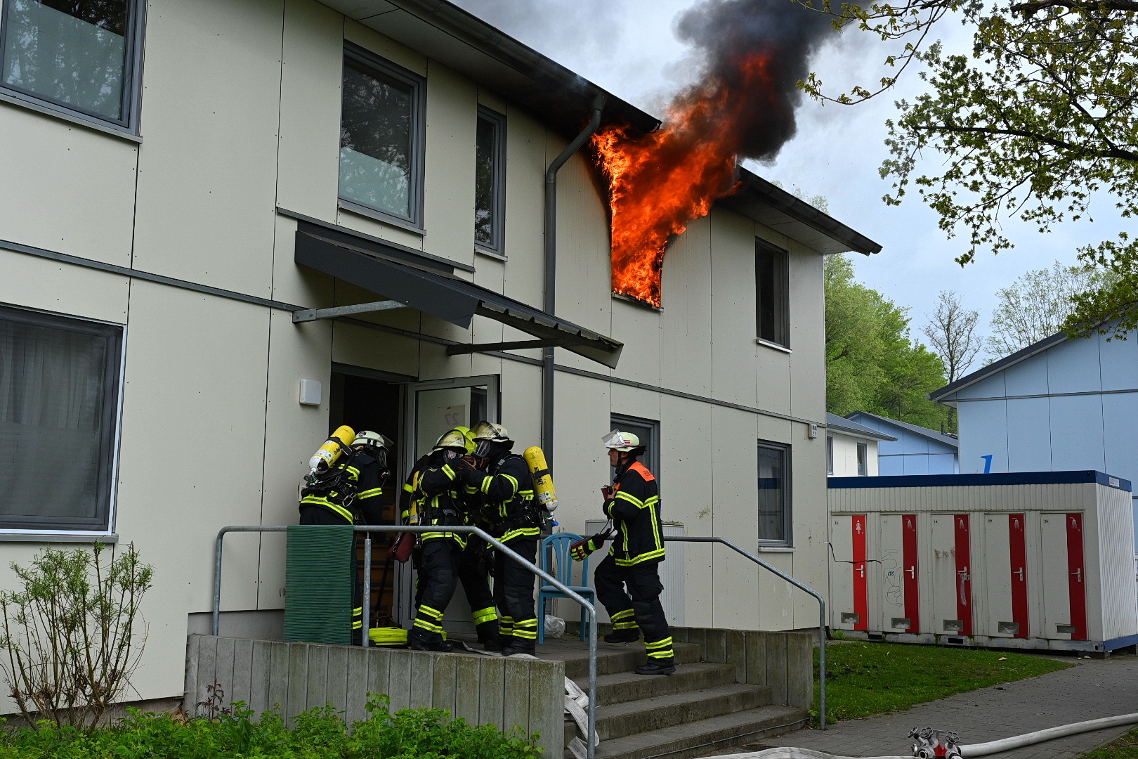 Meterhohe Flammen schlagen aus einem Fenster der Unterkunft.