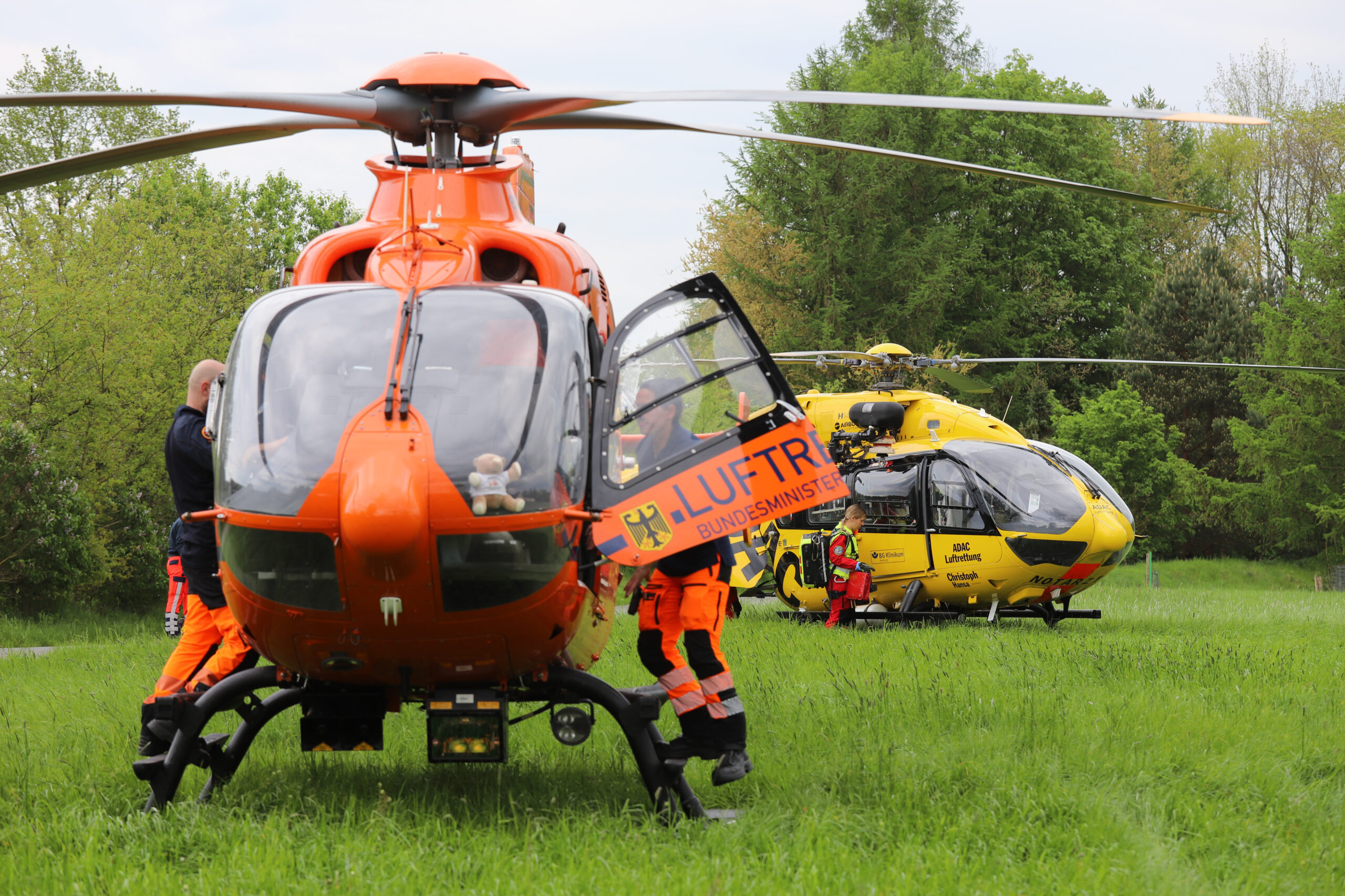 Einsatzkräfte steigen in die beiden Rettungshubschrauber am Unfallort.