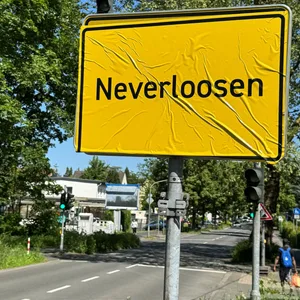 Das Ortsschild von Leverkusen wurde mit „Neverloosen“ überklebt