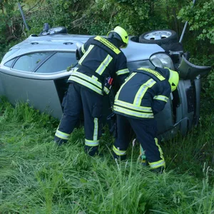 Feuerwehrkräfte am Unfallfahrzeug auf der A21 in Hammoor.