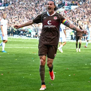 St. Pauli-Kapitän Jackson Irvine breitet die Arme aus und jubelt