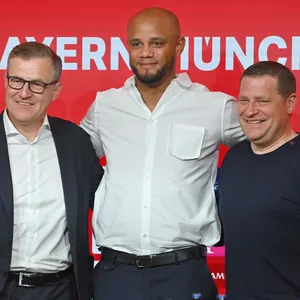 Vincent Kompany, Jan-Christian Dreesen und Max Eberl stehen Arm in Arm bei Kompany Vorstellung auf der Pressekonferenz