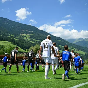 Der FC St. Pauli läuft vor einer malerischen Bergkulisse zu einem Testspiel im Trainingslager auf