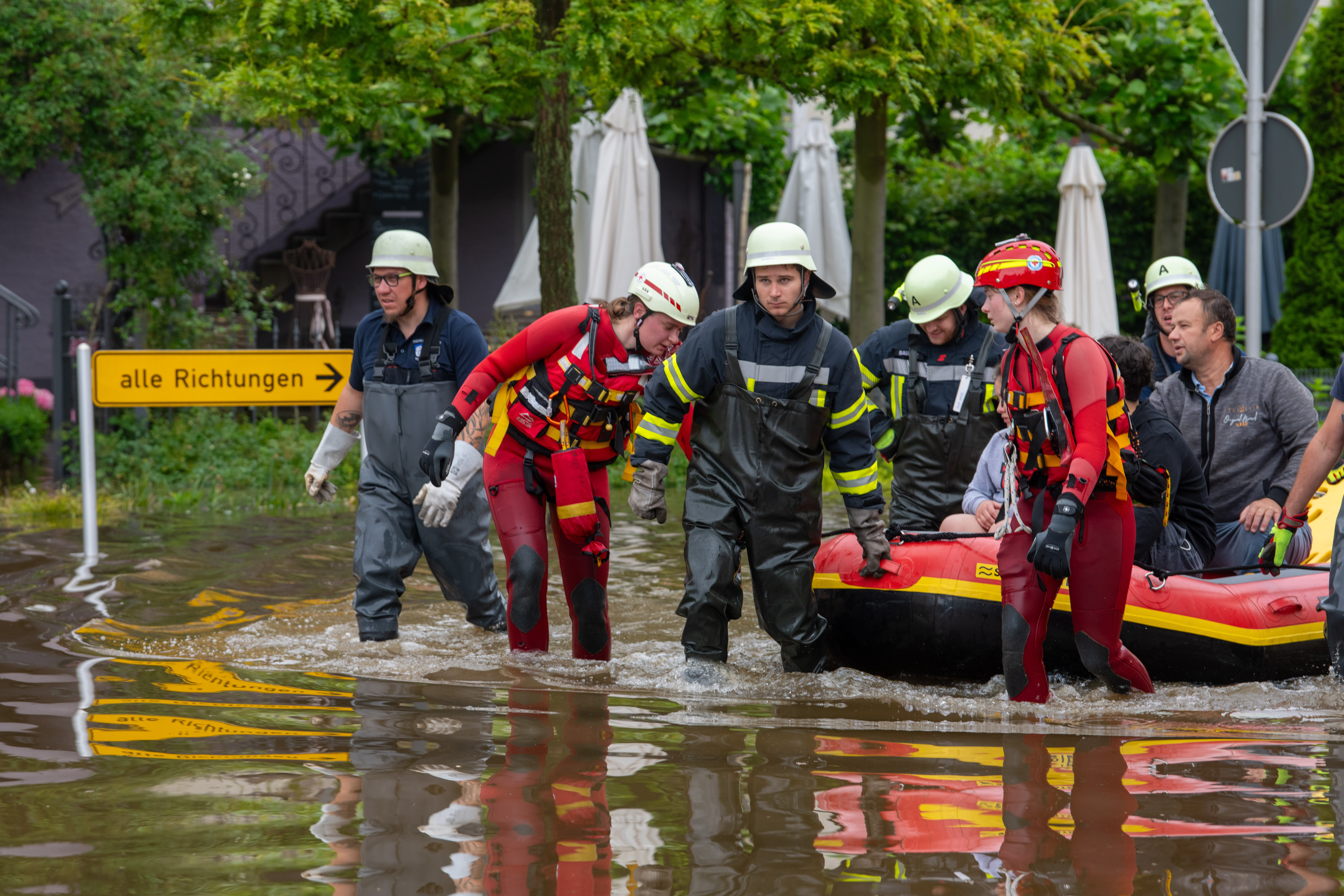 Mit einem Schlauchboot holen Feuerwehr und Wasserretter Anwohner aus ihren überfluteten Häusern.