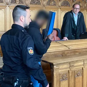 Der Angeklagte wird in den Saal des Landgerichts Bremen geführt.