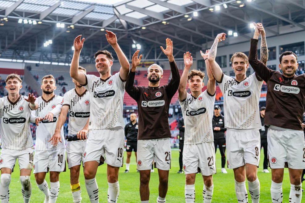 Spieler des FC St. Pauli feiern in Freiburg