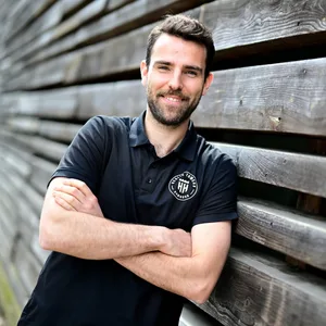 Benka Barloschky lehnt an eine Holzwand