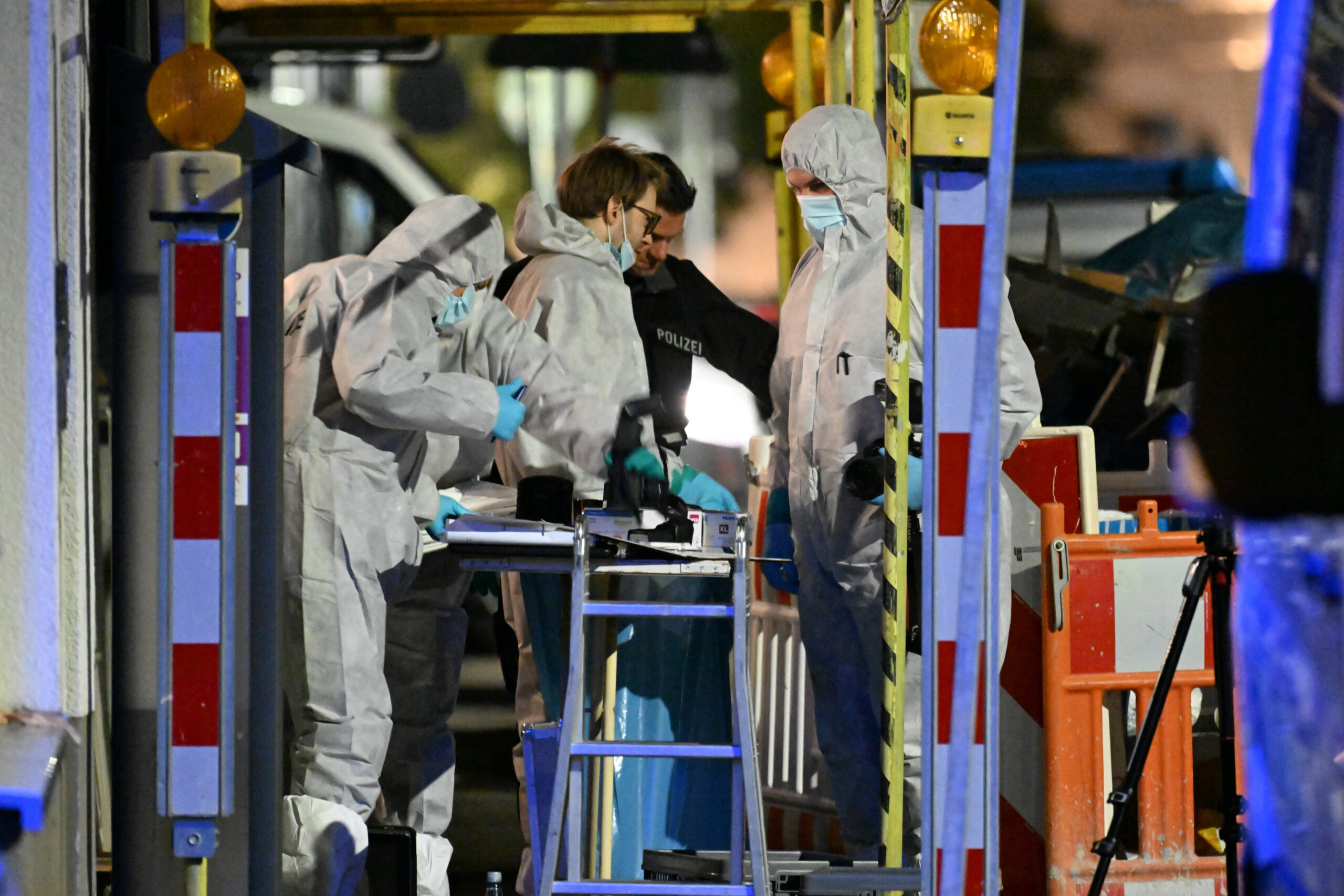 Männer in weißen Overalls bei der Spurensicherung