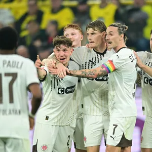 Eric Smith (2. v. r.) wird nach seinem Tor in Dortmund von seinen Teamkollegen geherzt.