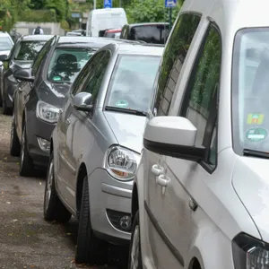 Autos, die halb auf dem Gehweg stehen