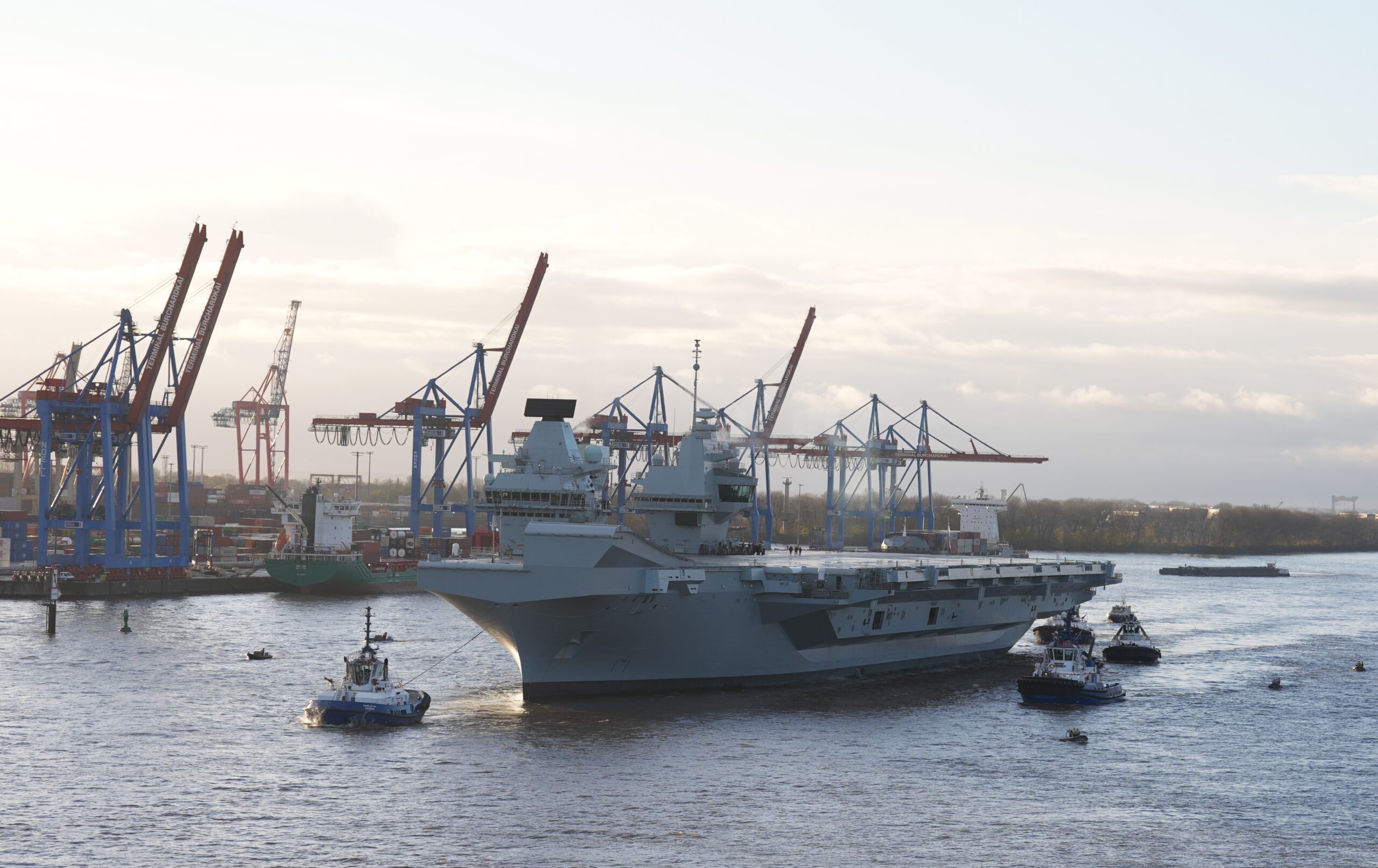 Der riesige Flugzeugträger wurde mit mehreren Schleppern in den Hafen gezogen.