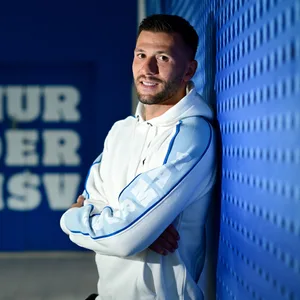 Daniel Heuer Fernandes lehnt sich an eine HSV-Wand