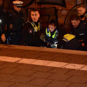 Beamte der Hamburger Polizei und der Bundespolizei helfen der jungen Frau aus dem Gleisbereich am S-Bahnhof Nettelnburg.