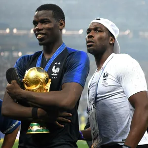 Paul Pogba und Mathias Pogba posieren zusammen mit dem WM-Pokal.