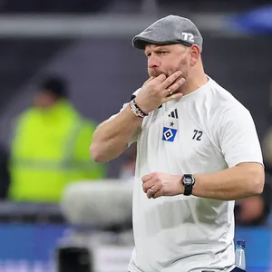 Steffen Baumgart pfeift mit Fingern im Mund