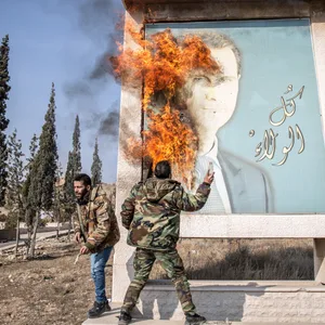 Oppositionelle zünden ein Porträt von Baschar al-Assad an. Sein Regime ist gefallen.