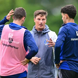 Trainer Merlin Polzin unterhält sich auf dem Trainingsplatz mit Jonas Meffert und Daniel Elfadli.