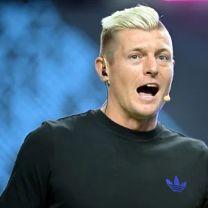 Toni Kroos ruft mit Mikrofon
