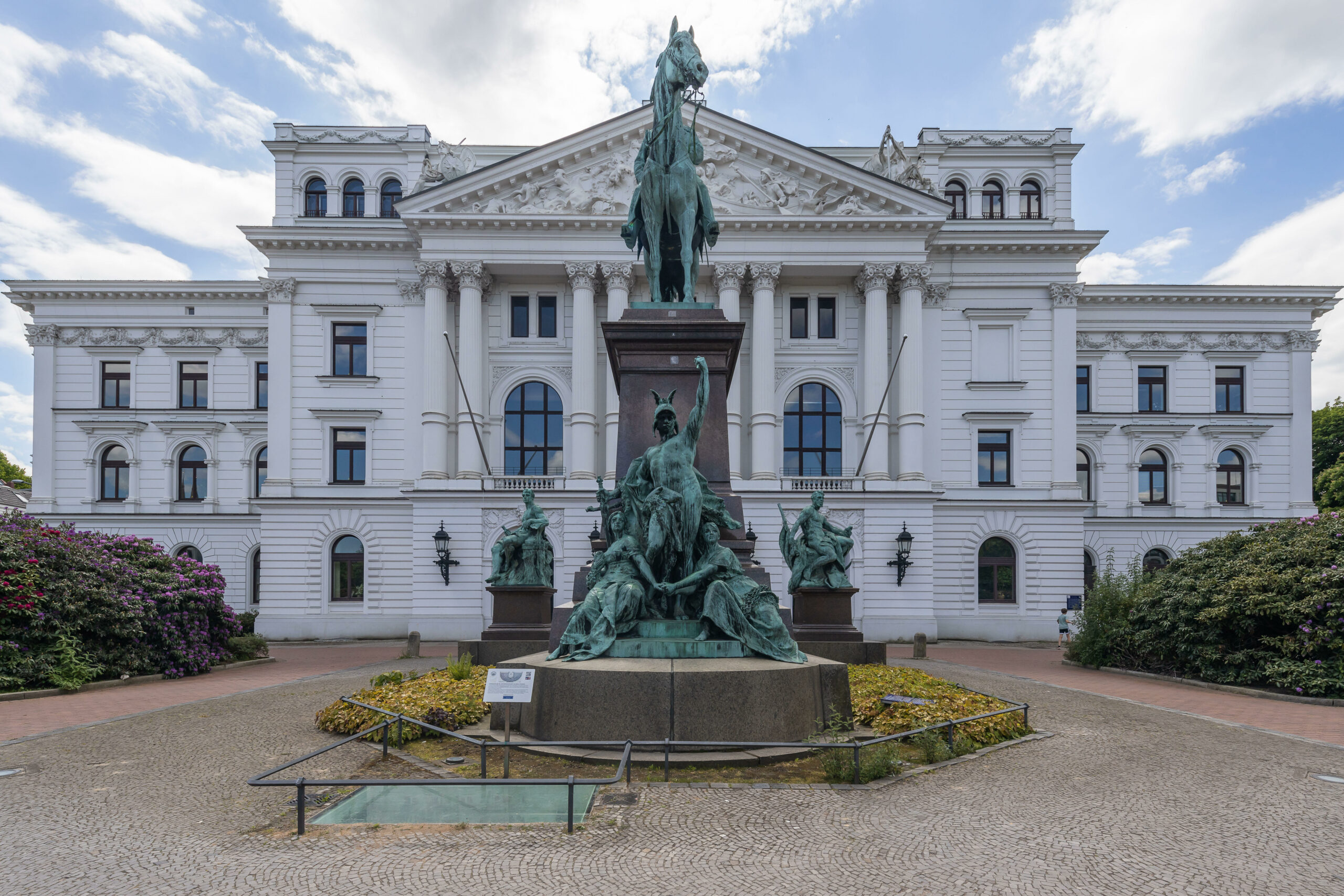 Weißes Haus mit Standbild davor