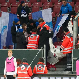 Sanitäter kümmern sich in Augsburg um verletzte Fans