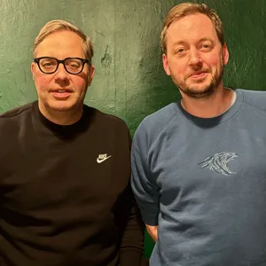 Philipp Köster und Stephan Reich stehen vor einer grünen Wand.