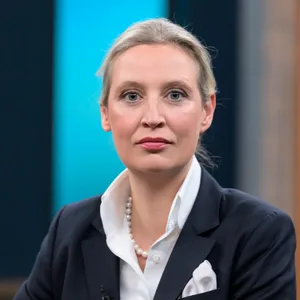 Blonde Frau mit weißer Bluse und Perlenkette