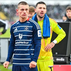 Miro Muheim und Daniel Heuer Fernandes gucken enttäuscht in die HSV-Fankurve in Ulm
