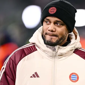 Vincent Kompany in Winterjacke und Mütze im Stadion