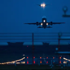 Ein Flugzeug im Landeanflug bei Nacht