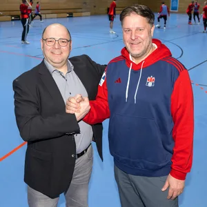 Christian Hüneburg und Philipp J. Müller geben sich in der Handball-Halle die Hand