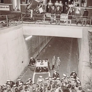 Die beiden zertrümmerten S-Bahnen stehen im Bahnhof Stellingen. In einem Durchgang unter den Gleisen drängen Polizisten HSV-Fans ab.