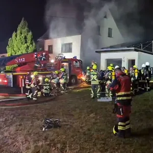 Einsatzkräfte der Feuerwehr löschen einen Brand.