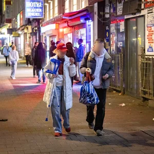 Zwei Abhängige kommen im Dunkeln auf die Kamera zu