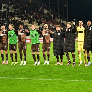 St. Paulis Profis feierten das Unentschieden gegen Leverkusen nach dem Spiel mit ihren Fans wie einen Sieg,.