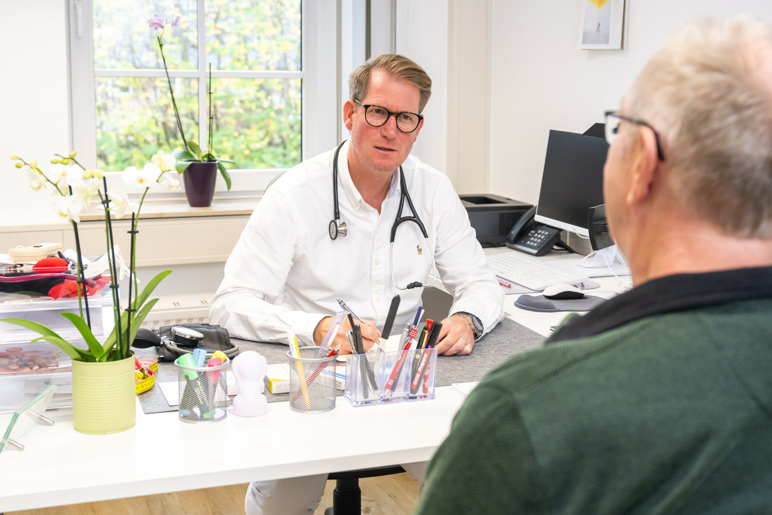 Ein Patient sitzt vor einem Arzt.