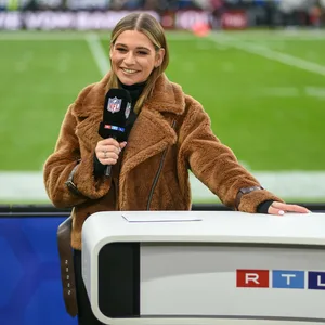 Jana Wosnitza steht am RTL-Pult und lächelt