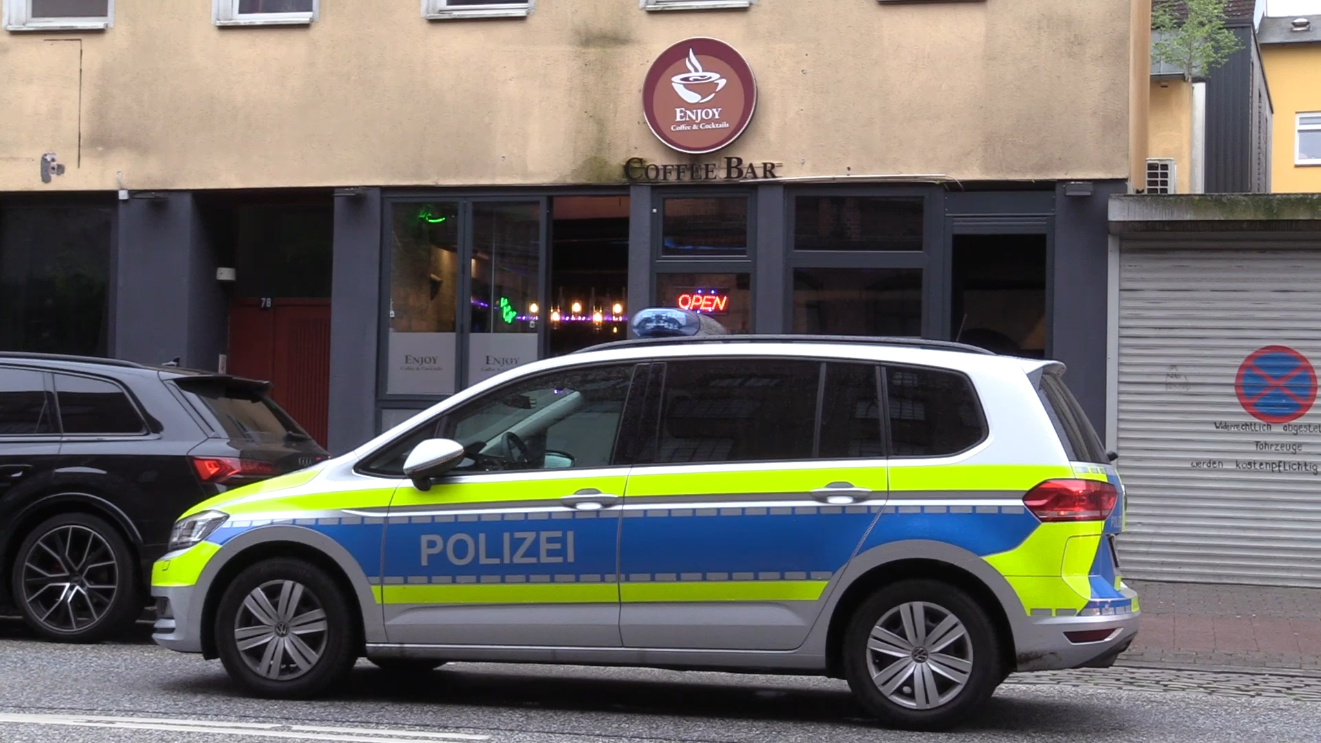 Ein Streifenwagen vor dem Café „Enjoy“ an der Wilstorfer Straße in Hamburg-Harburg.