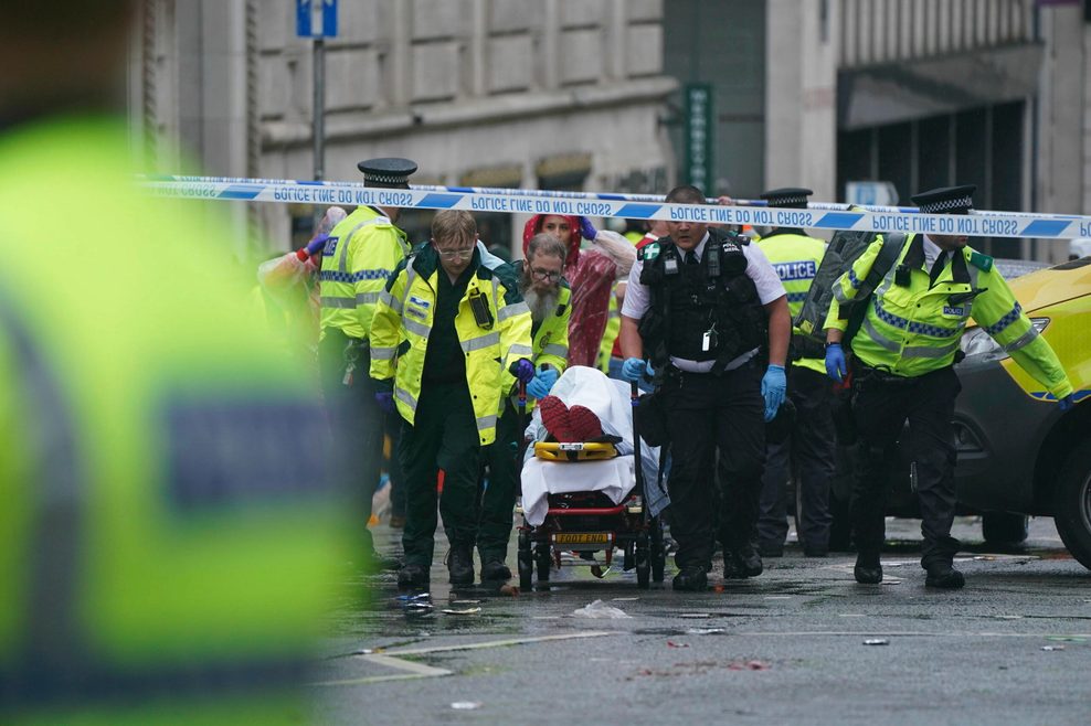 Polizei und Rettungskräfte kümmern sich um einen Verletzten in der Nähe des Liver Building während der Premier-League-Siegerparade in Liverpool.