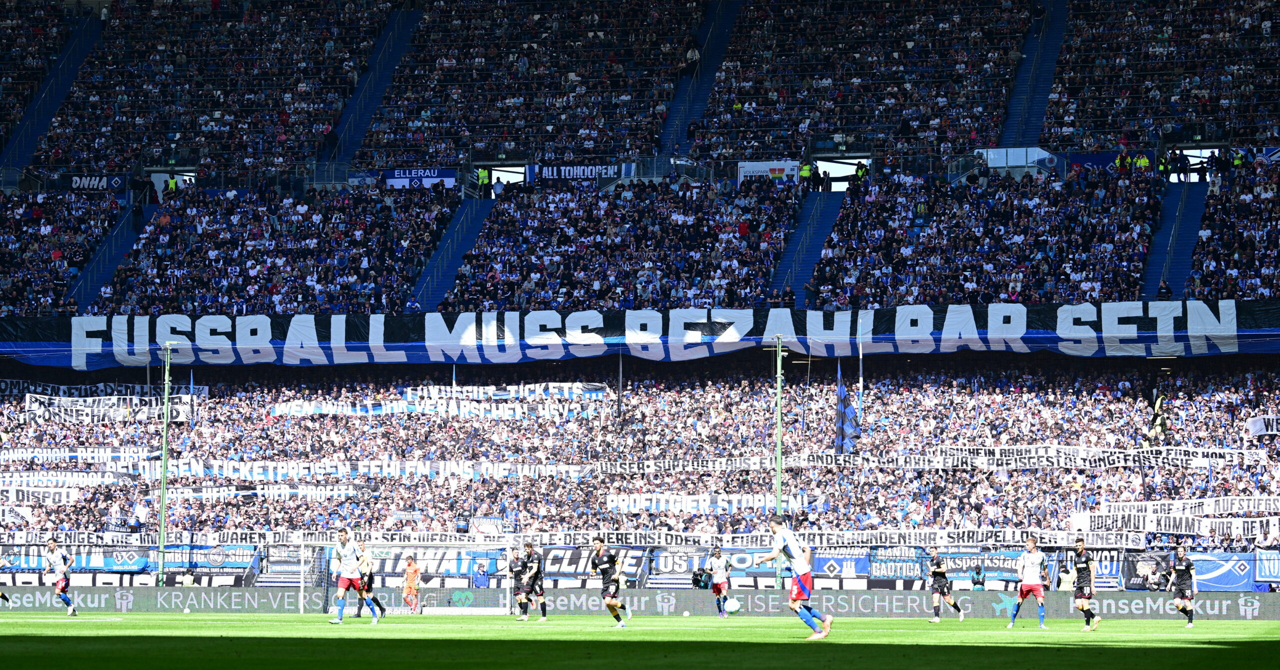 Auf der Nordtribüne im Volksparkstadion hängt ein großes Plakat mit der Aufschrift: „Fußball muss bezahlbar sein“
