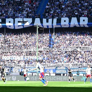Auf der Nordtribüne im Volksparkstadion hängt ein großes Plakat mit der Aufschrift: „Fußball muss bezahlbar sein“